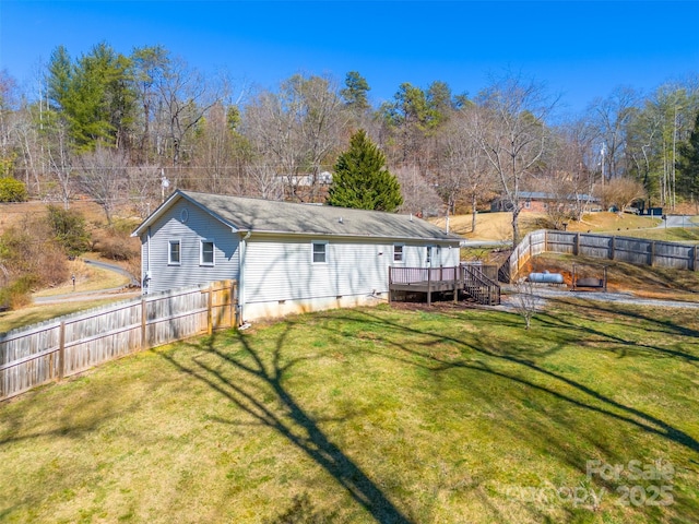 view of yard with a deck and fence