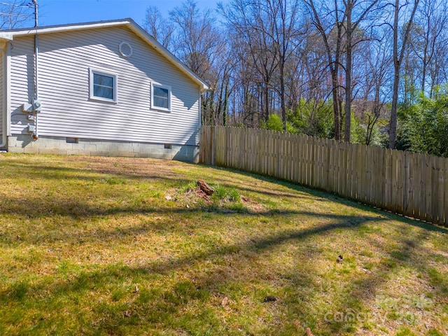 view of home's exterior featuring fence, a lawn, and crawl space