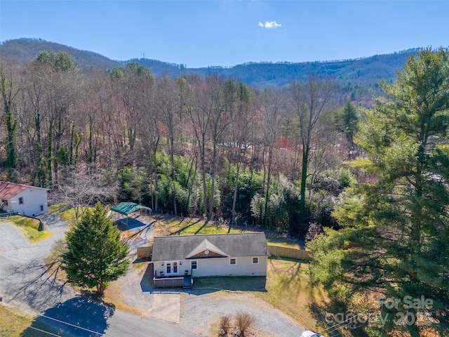 drone / aerial view with a wooded view