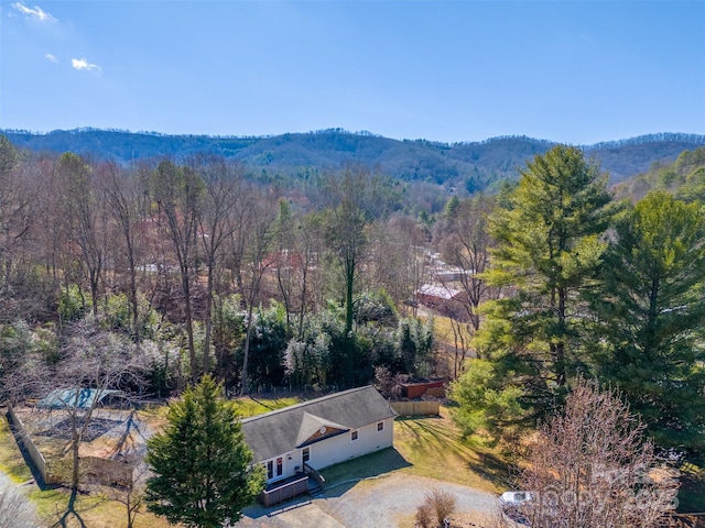 drone / aerial view featuring a forest view and a mountain view