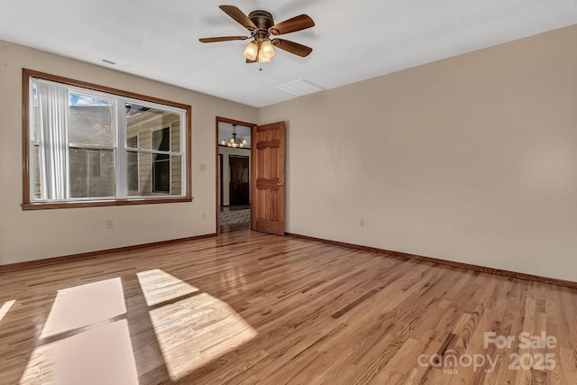 unfurnished room featuring light wood-type flooring, baseboards, visible vents, and a ceiling fan