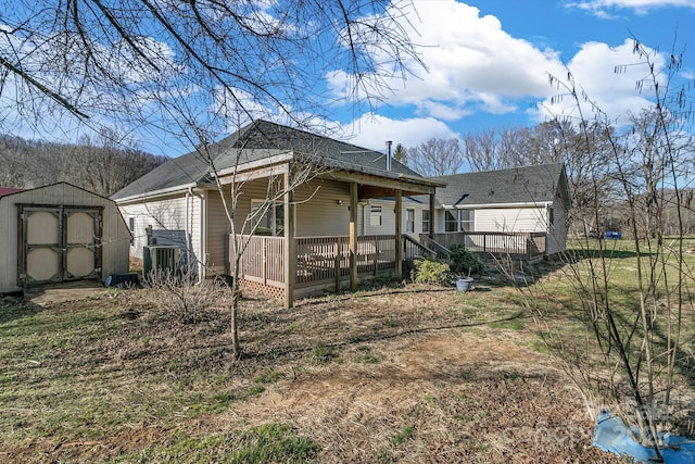 view of home's exterior with an outbuilding, a porch, and a shed