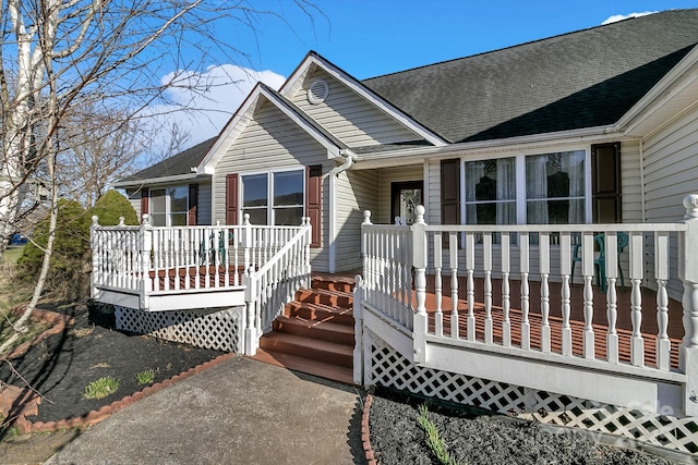 rear view of house featuring covered porch