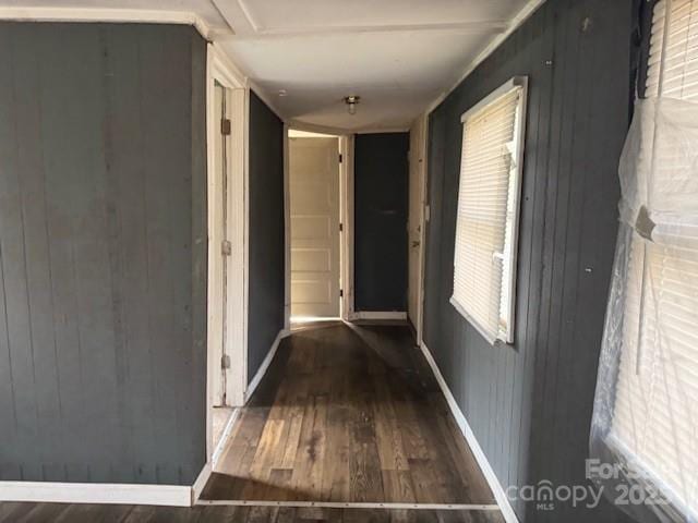 hallway with baseboards and wood finished floors