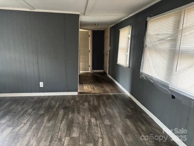 spare room with wood finished floors and baseboards