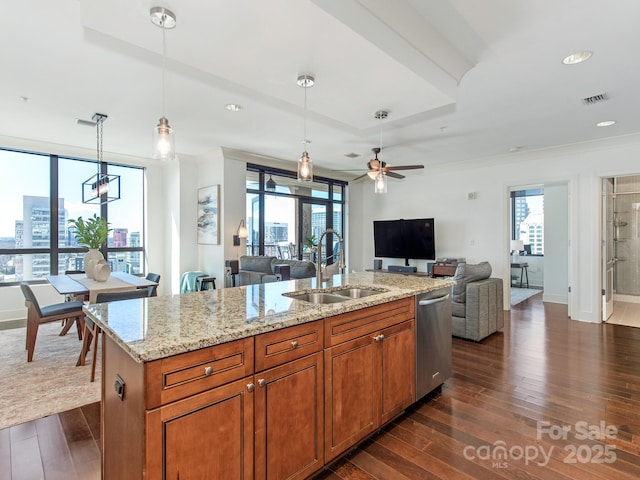 kitchen featuring dishwasher, visible vents, open floor plan, and a sink