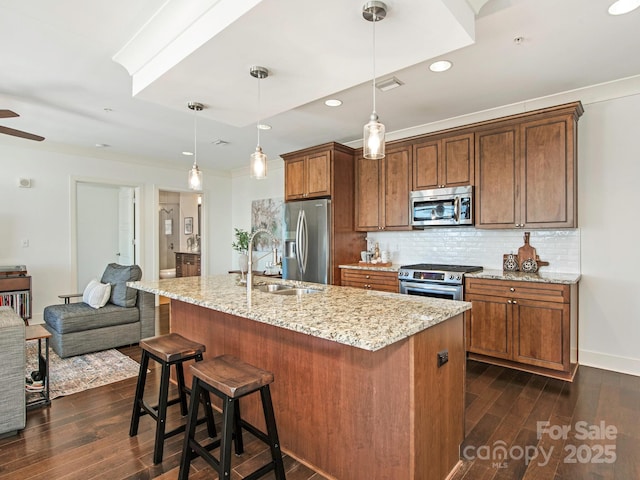 kitchen with dark wood-style floors, backsplash, stainless steel appliances, and a sink