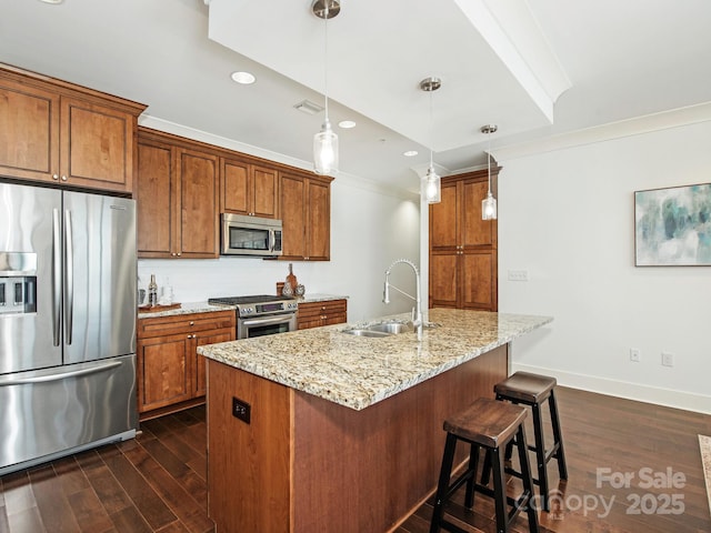 kitchen featuring brown cabinetry, appliances with stainless steel finishes, and a sink