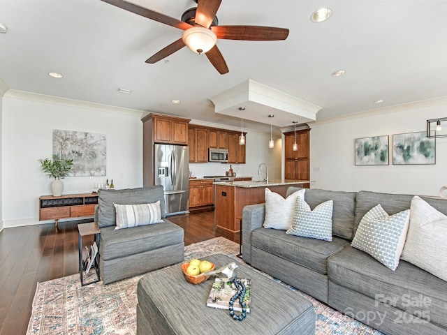 living room with recessed lighting, ornamental molding, dark wood finished floors, and ceiling fan