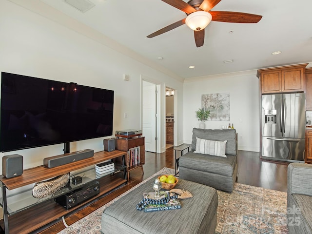 living room with recessed lighting, wood finished floors, visible vents, and baseboards