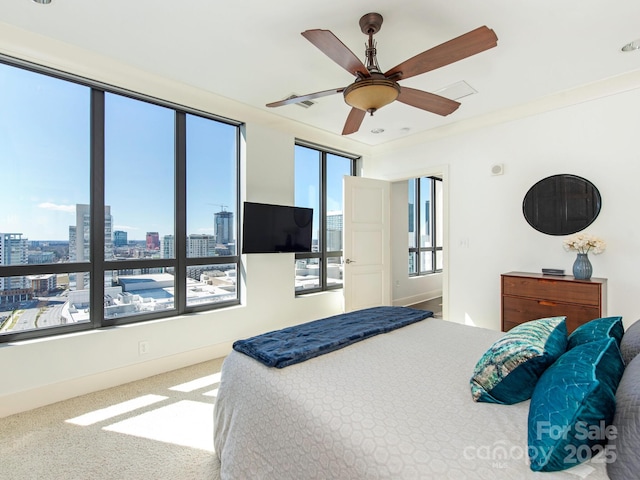 carpeted bedroom with baseboards and a ceiling fan