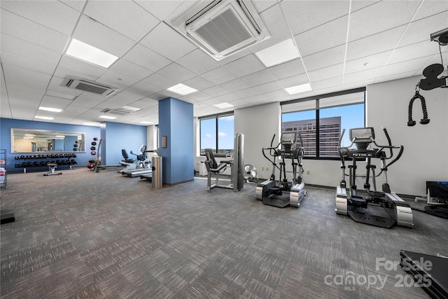 workout area featuring carpet flooring, visible vents, and a drop ceiling