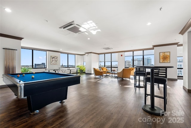 playroom with pool table, a wall of windows, ornamental molding, wood finished floors, and a view of city