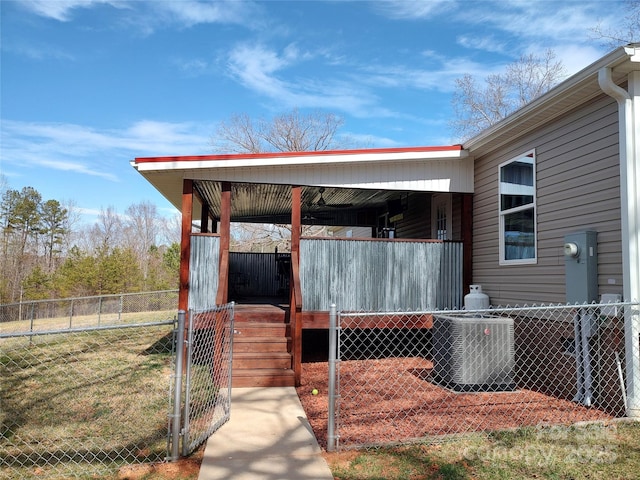 exterior space featuring central AC unit and fence