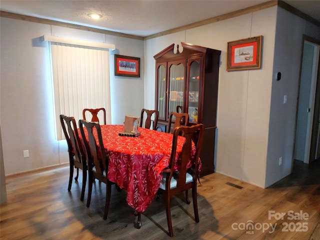 dining area featuring wood finished floors and visible vents