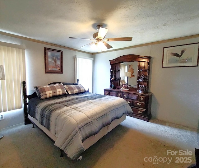 bedroom with carpet flooring, a textured ceiling, crown molding, and a ceiling fan