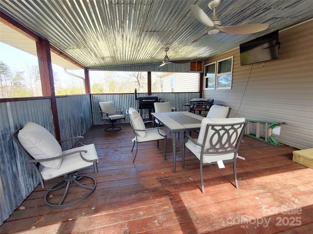 wooden terrace with outdoor dining space and a ceiling fan