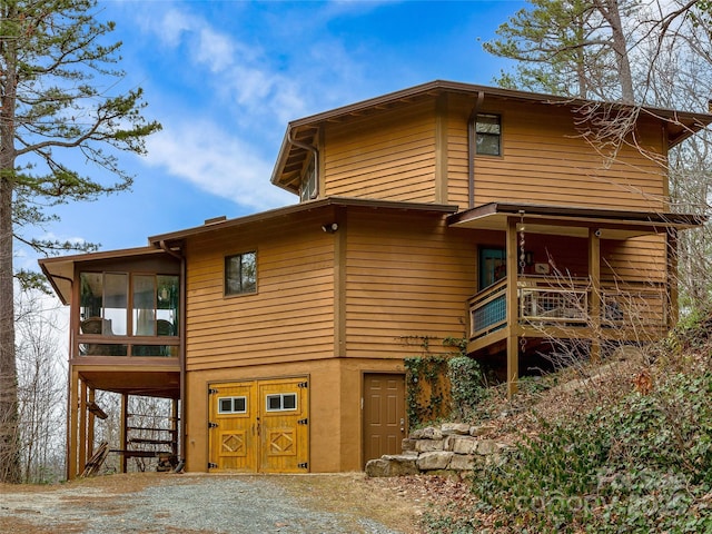 rear view of property with a sunroom