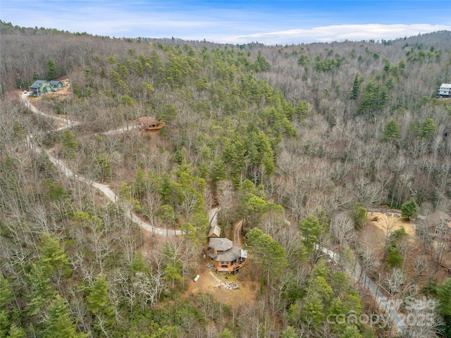 bird's eye view featuring a wooded view