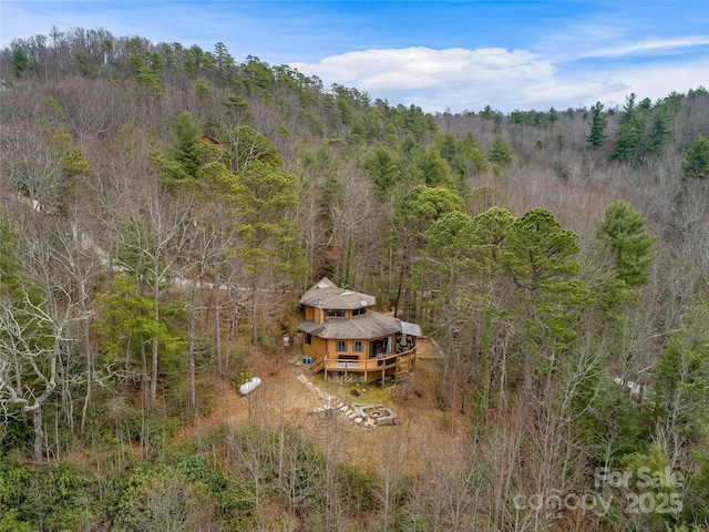 aerial view featuring a wooded view