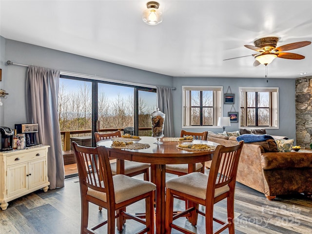 dining area featuring dark wood-type flooring and ceiling fan