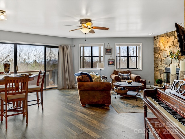 living area with ceiling fan and wood finished floors