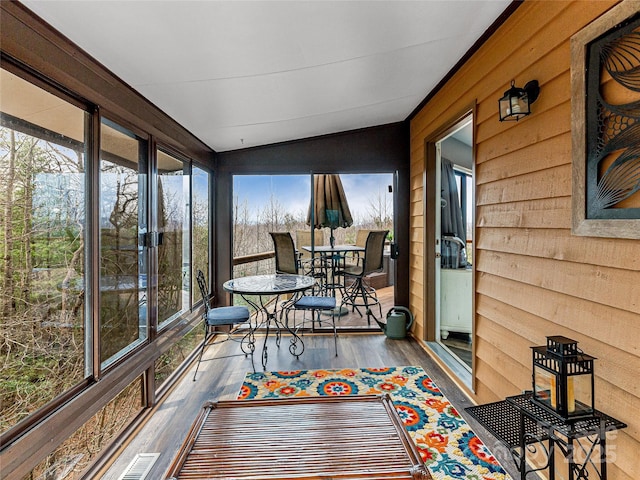 sunroom / solarium featuring vaulted ceiling