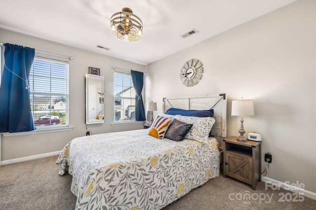 bedroom with baseboards, visible vents, and carpet floors