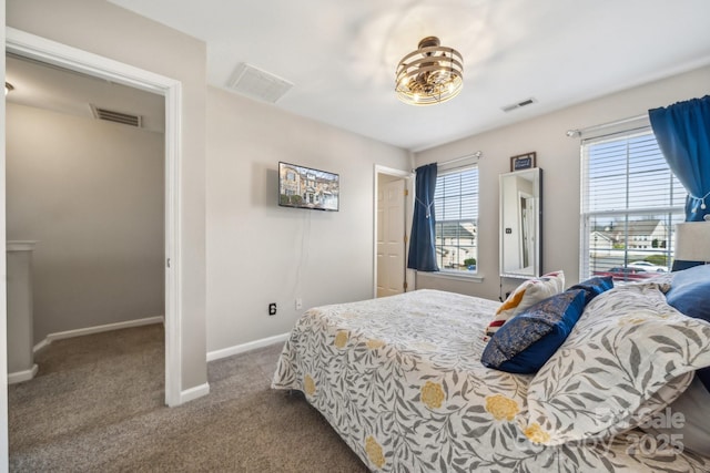 carpeted bedroom featuring baseboards and visible vents