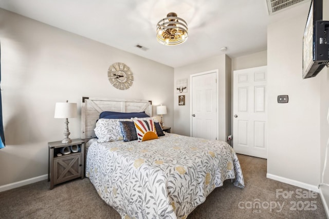 carpeted bedroom with visible vents and baseboards