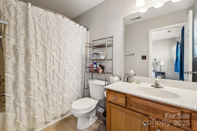 full bath with visible vents, toilet, vanity, and tile patterned flooring