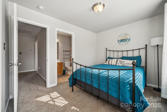 bedroom featuring baseboards, carpet floors, and ensuite bath