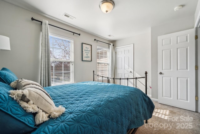 bedroom with visible vents, baseboards, carpet, and a closet