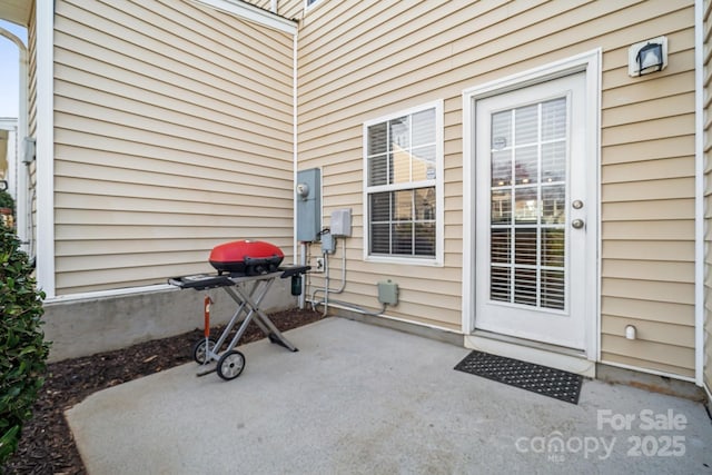 view of exterior entry featuring a patio area