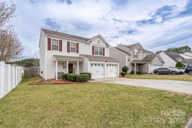 traditional home with concrete driveway, a garage, fence, and a front lawn