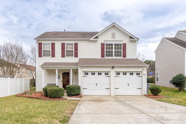 traditional-style house with a front yard, fence, a garage, and driveway