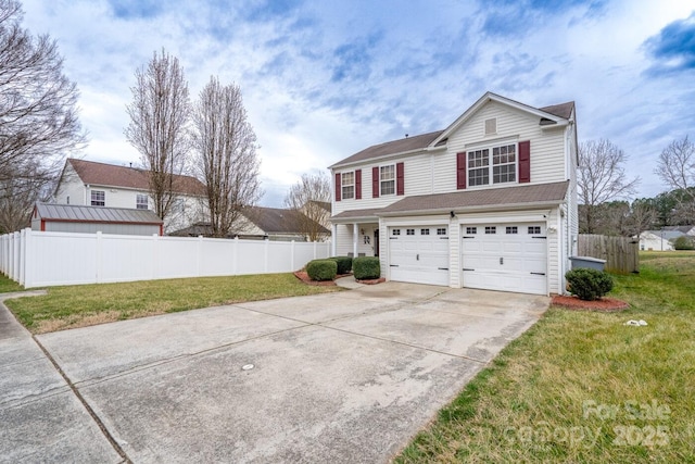 traditional-style house with a front yard, concrete driveway, fence, and an attached garage