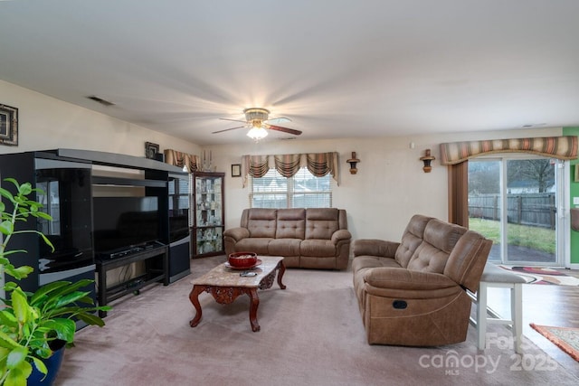 living room with visible vents and ceiling fan