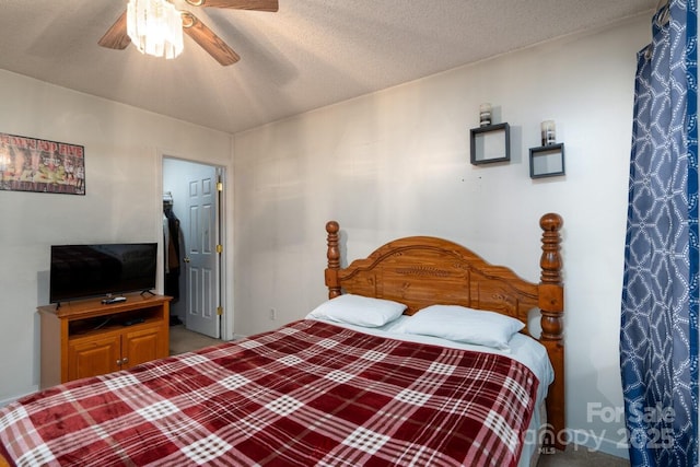 bedroom with a textured ceiling and ceiling fan