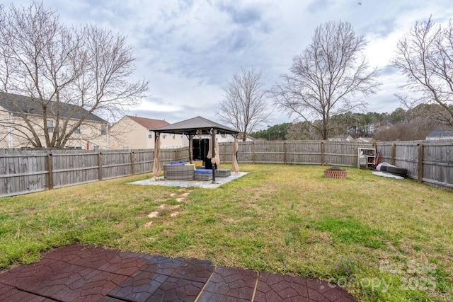 view of yard featuring a gazebo, a patio, a fenced backyard, and an outdoor fire pit