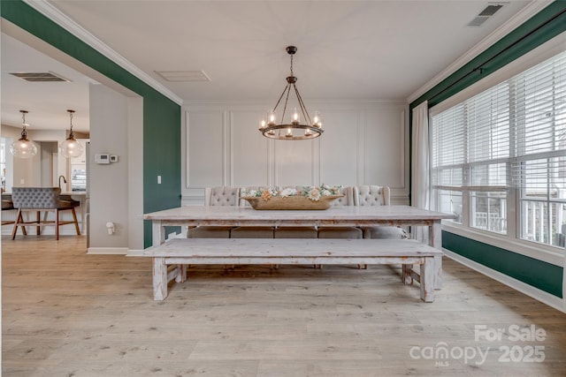 unfurnished dining area with a decorative wall, ornamental molding, visible vents, and breakfast area