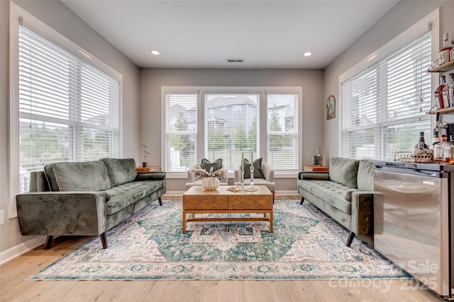 living room featuring visible vents, recessed lighting, baseboards, and wood finished floors
