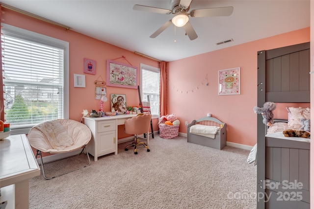 bedroom featuring visible vents, baseboards, light colored carpet, and a ceiling fan