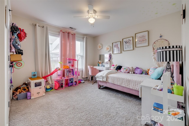 bedroom with visible vents, a ceiling fan, and carpet