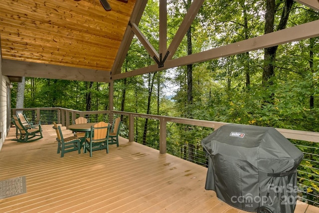 wooden deck with a grill and outdoor dining space