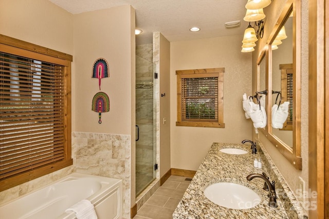 bathroom featuring a garden tub, tile patterned floors, a shower stall, and a sink