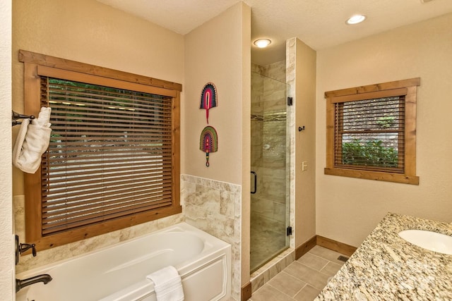 full bath with vanity, baseboards, a stall shower, a garden tub, and tile patterned floors