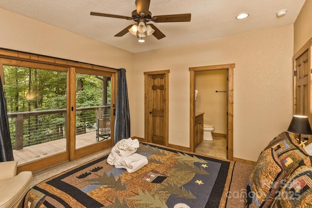 bedroom featuring a textured ceiling, ensuite bathroom, baseboards, and access to outside