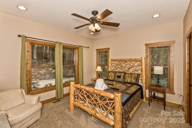 carpeted bedroom featuring recessed lighting, baseboards, and a textured ceiling