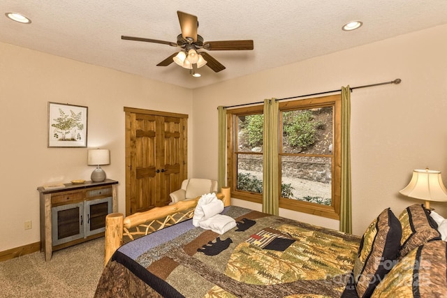 carpeted bedroom featuring recessed lighting, a textured ceiling, and ceiling fan